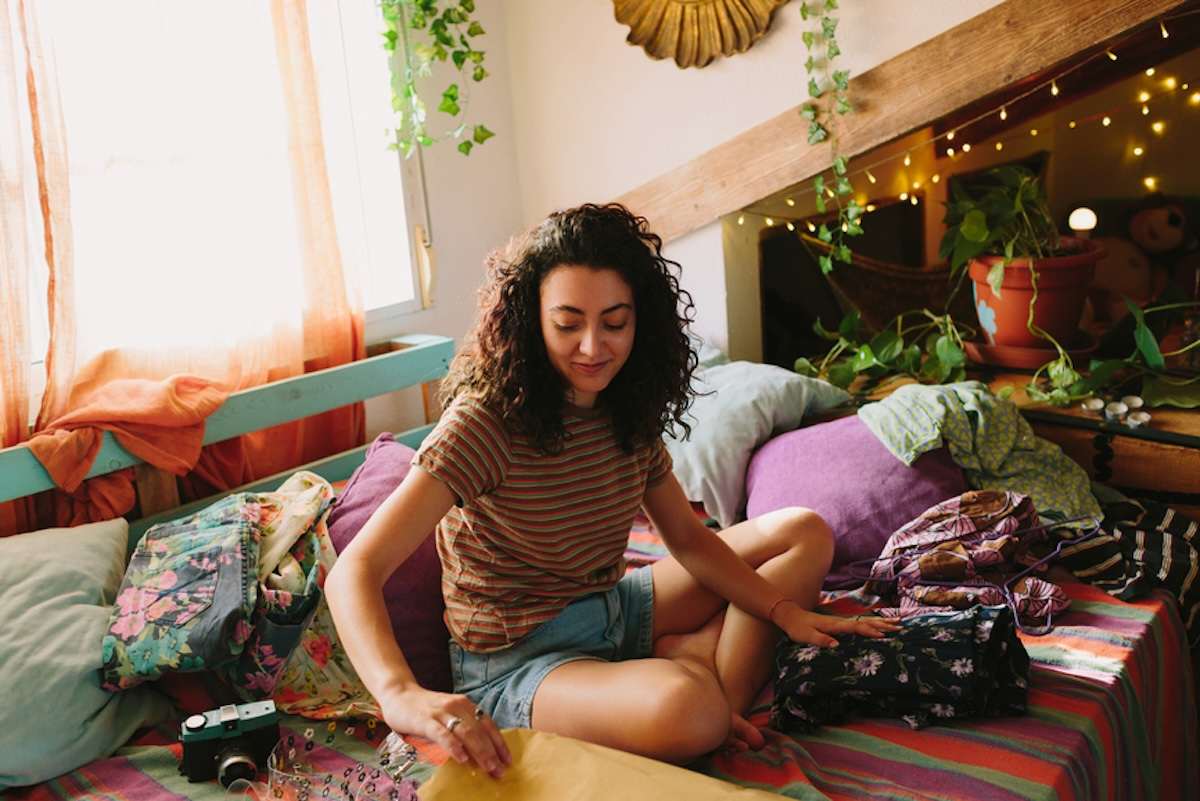 Person sorting through clothes for donation